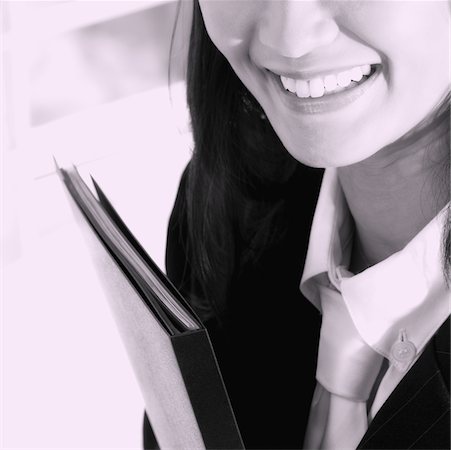 simsearch:625-01095402,k - Close-up of a businesswoman holding a file and smiling Foto de stock - Sin royalties Premium, Código: 625-01095417