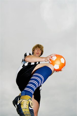 Low angle view of a soccer player practicing Stock Photo - Premium Royalty-Free, Code: 625-01095490