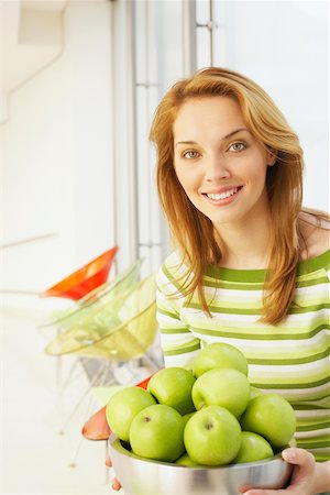 photo of apples in a white bowl - Portrait of a young woman holding a bowl of green apples Stock Photo - Premium Royalty-Free, Code: 625-01096084