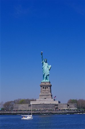 statue of liberty with american flag - Statue at the waterfront, Statue Of Liberty, New York City, New York State, USA Stock Photo - Premium Royalty-Free, Code: 625-01096397