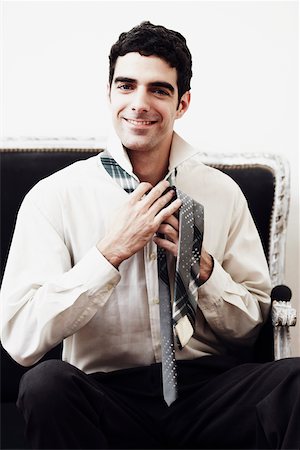 simsearch:625-01096675,k - Portrait of a businessman tying his tie Stock Photo - Premium Royalty-Free, Code: 625-01096558
