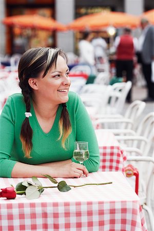 Young woman sitting at a sidewalk cafe Stock Photo - Premium Royalty-Free, Code: 625-01096563