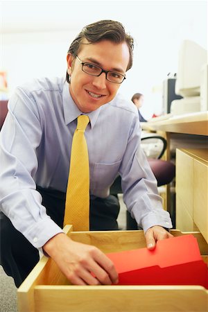 simsearch:625-01096766,k - Portrait of a businessman holding a file in a drawer Stock Photo - Premium Royalty-Free, Code: 625-01096724