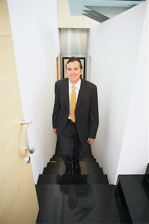 simsearch:625-01096675,k - Portrait of a businessman walking up stairs Stock Photo - Premium Royalty-Free, Code: 625-01096805