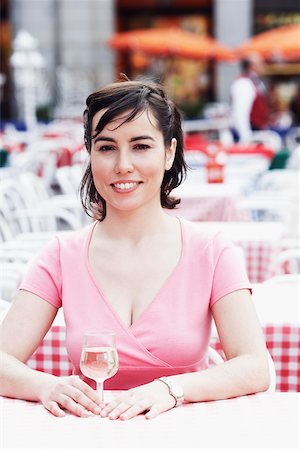 simsearch:625-02267871,k - Portrait of a young woman sitting at a table in a sidewalk cafe Stock Photo - Premium Royalty-Free, Code: 625-01096814