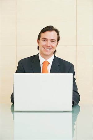 simsearch:625-01096675,k - Portrait of a businessman sitting in front of a laptop Stock Photo - Premium Royalty-Free, Code: 625-01097040