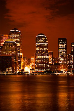 Skyscrapers at the waterfront lit up at night, New York City, New York State, USA Stock Photo - Premium Royalty-Free, Code: 625-01097117