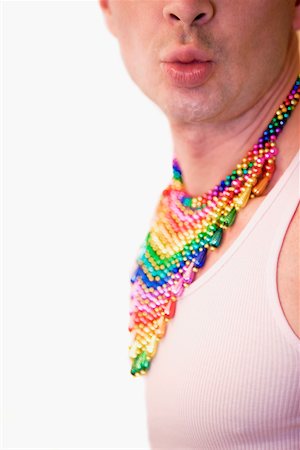 Close-up of a gay man wearing a colorful necklaces and puckering his lips Stock Photo - Premium Royalty-Free, Code: 625-01097189