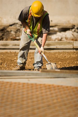 simsearch:625-01097225,k - Construction worker using a shovel at a construction site Stock Photo - Premium Royalty-Free, Code: 625-01097196