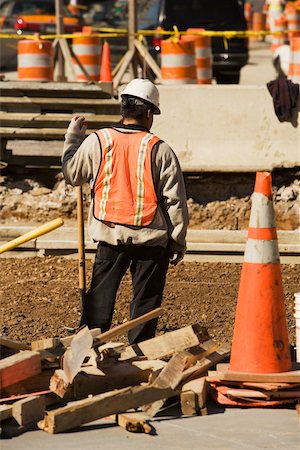 Rear view of a construction worker working at a construction site Stock Photo - Premium Royalty-Free, Code: 625-01097198