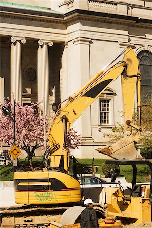 Bulldozer in front of a building Stock Photo - Premium Royalty-Free, Code: 625-01097201