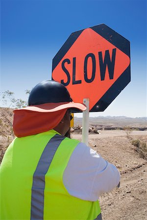 simsearch:625-01097231,k - Rear view of a man standing with a road sign Stock Photo - Premium Royalty-Free, Code: 625-01097210