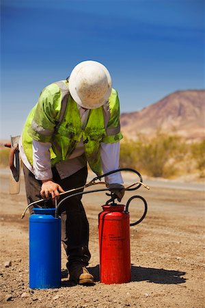 simsearch:625-01097225,k - Construction worker holding two cylinders Stock Photo - Premium Royalty-Free, Code: 625-01097225