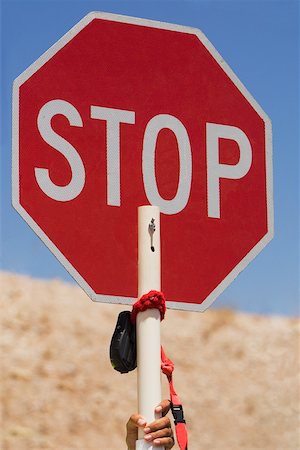 simsearch:625-01097231,k - Close-up of a human hand holding a stop sign Stock Photo - Premium Royalty-Free, Code: 625-01097228