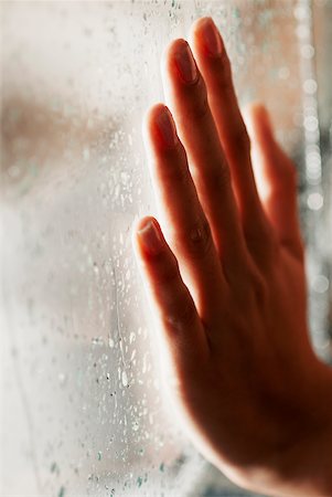 finger wet glass - Close-up of a human hand on a glass window Stock Photo - Premium Royalty-Free, Code: 625-01097404