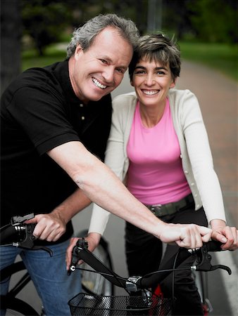 simsearch:6108-08663171,k - Portrait of a mature couple standing with bicycles and smiling Stock Photo - Premium Royalty-Free, Code: 625-01097434
