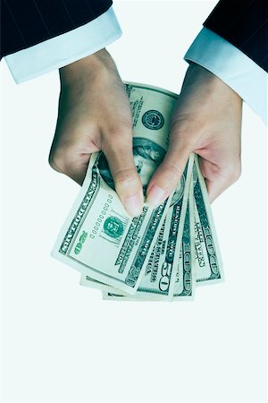 High angle view of a businesswoman's hand holding dollar bills Fotografie stock - Premium Royalty-Free, Codice: 625-01097540