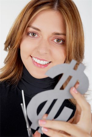 student latino business casual - Portrait of a businesswoman holding a dollar sign with a pair of scissors and smiling Stock Photo - Premium Royalty-Free, Code: 625-01097774
