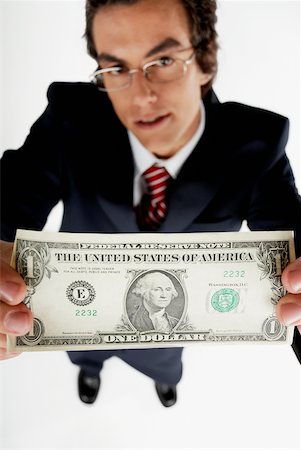 simsearch:625-00850993,k - Portrait of a businessman holding an American dollar bill Stock Photo - Premium Royalty-Free, Code: 625-01097814