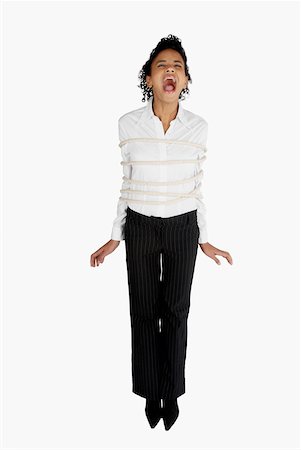 screaming woman in fear - Businesswoman tied up with a rope and screaming Stock Photo - Premium Royalty-Free, Code: 625-01097825