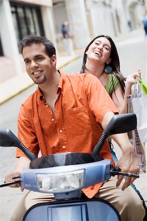 student latino business casual - Close-up of a mid adult man and a teenage girl riding a scooter Stock Photo - Premium Royalty-Free, Code: 625-01097940