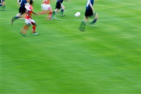 socks group - Soccer player playing soccer in a soccer field Stock Photo - Premium Royalty-Free, Code: 625-01091877