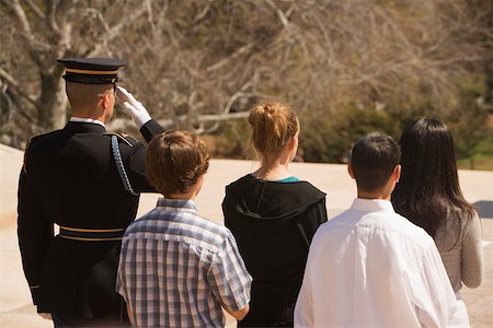 Rear view of four people standing with an honor guard Stock Photo - Premium Royalty-Free, Code: 625-01092026