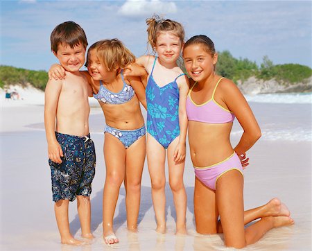 ethnic preteens swimwear girls - Close-up of a boy and his three sisters on the beach, Bermuda Stock Photo - Premium Royalty-Free, Code: 625-01092058