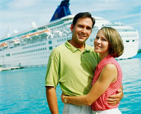 ship boat front view - Portrait of a young couple embracing each other in front of a cruise ship, Bermuda Stock Photo - Premium Royalty-Free, Code: 625-01092124