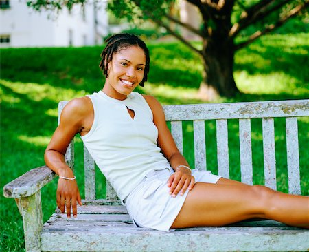 Portrait of a young woman sitting on a bench and smiling, Bermuda Stock Photo - Premium Royalty-Free, Code: 625-01092137