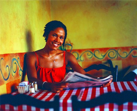 painting of people in a restaurant - Portrait of a young woman holding a newspaper and smiling in a restaurant, Bermuda Stock Photo - Premium Royalty-Free, Code: 625-01092147