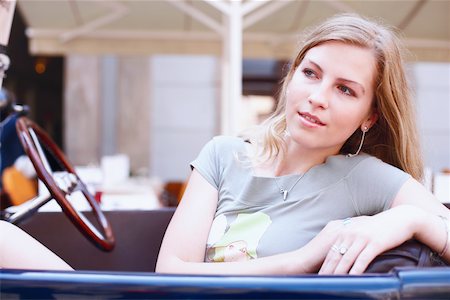 Close-up of a young woman in a car Stock Photo - Premium Royalty-Free, Code: 625-01092534