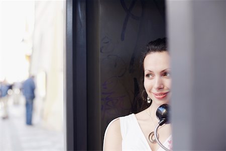 Young woman in a telephone booth Stock Photo - Premium Royalty-Free, Code: 625-01092590