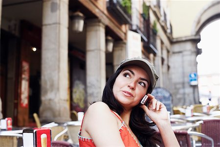 simsearch:625-01097695,k - Side profile of a mid adult woman sitting at a sidewalk cafe and talking on a mobile phone Foto de stock - Royalty Free Premium, Número: 625-01092651