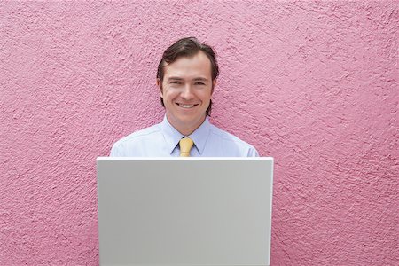 simsearch:625-01096766,k - Portrait of a businessman holding a laptop Stock Photo - Premium Royalty-Free, Code: 625-01092675