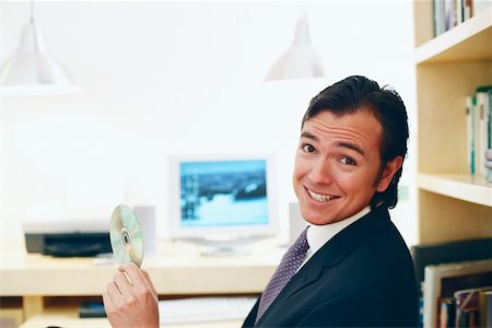 Portrait of a businessman holding a CD Foto de stock - Sin royalties Premium, Código: 625-01092766