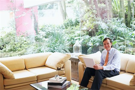 simsearch:625-01096766,k - Portrait of a businessman sitting on a couch with a laptop Stock Photo - Premium Royalty-Free, Code: 625-01092851