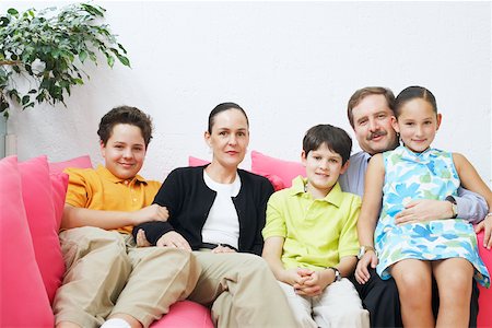 simsearch:6108-08662912,k - Portrait of a family sitting on a couch Stock Photo - Premium Royalty-Free, Code: 625-01092921