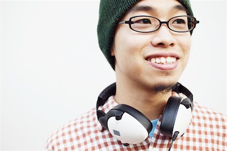 simsearch:625-01265118,k - Close-up of a young man with headphones around his neck Fotografie stock - Premium Royalty-Free, Codice: 625-01092938