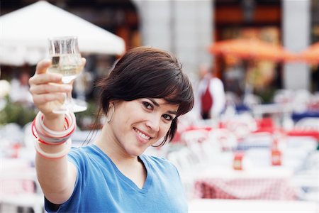 simsearch:625-02267871,k - Portrait of a young woman holding up a glass of white wine Stock Photo - Premium Royalty-Free, Code: 625-01093033