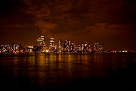 Skyscrapers at the waterfront lit up at night, New York City, New York State, USA Stock Photo - Premium Royalty-Free, Code: 625-01093234