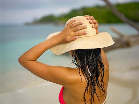 Rear view of a young woman wearing a sun hat Stock Photo - Premium Royalty-Free, Code: 625-01093267