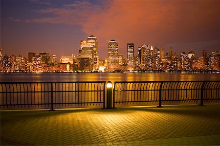 Skyscrapers at the waterfront lit up at night, New York City, New York State, USA Stock Photo - Premium Royalty-Free, Code: 625-01093262