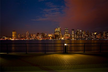 Skyscrapers at the waterfront lit up at night, New York City, New York State, USA Stock Photo - Premium Royalty-Free, Code: 625-01093300
