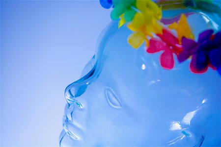 Close-up of a garland of artificial flowers on the head of a transparent statue Stock Photo - Premium Royalty-Free, Code: 625-01093320