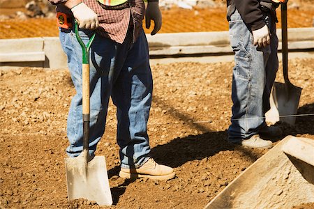 simsearch:625-01097231,k - Low section view of two construction workers standing and holding shovels Stock Photo - Premium Royalty-Free, Code: 625-01093355