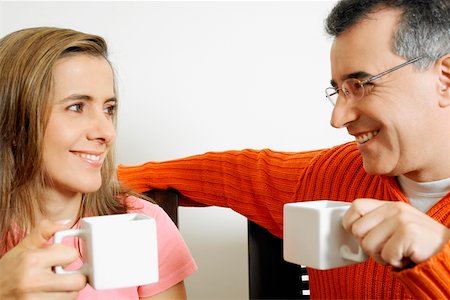 Close-up of a mid adult couple holding two cups of coffee Stock Photo - Premium Royalty-Free, Code: 625-01093515