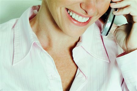simsearch:625-01093712,k - Close-up of a businesswoman talking on a mobile phone and smiling Stock Photo - Premium Royalty-Free, Code: 625-01093604