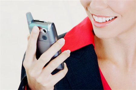 simsearch:625-01095402,k - Close-up of a businesswoman holding a mobile phone and smiling Foto de stock - Sin royalties Premium, Código: 625-01093603