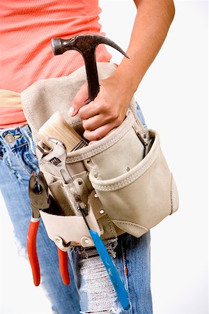 Mid section view of a person holding a hammer in a tool belt Foto de stock - Sin royalties Premium, Código: 625-01249607